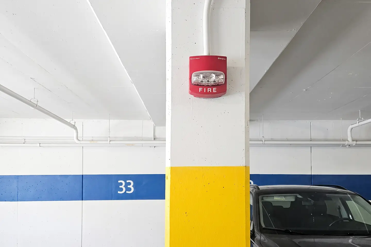 Fire alarm horn strobe mounted on a parkade column