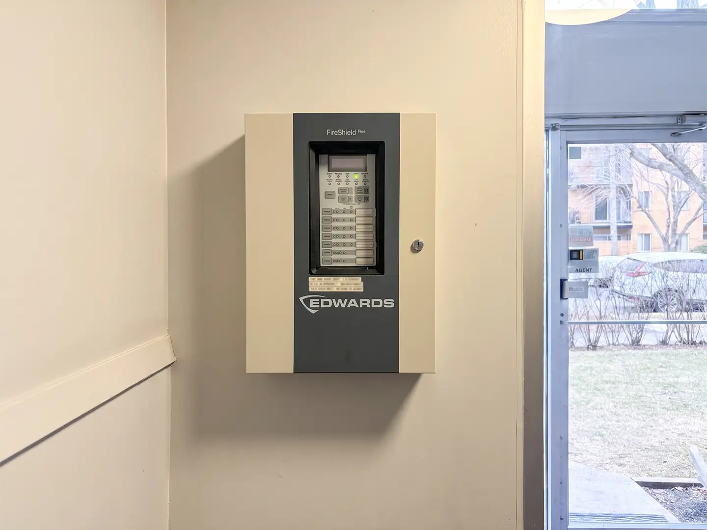 Fire alarm control panel mounted in a commercial building entryway